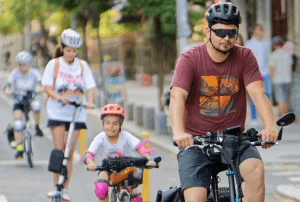 Father riding bicycles with his children outdoors, promoting healthy and active family lifestyles